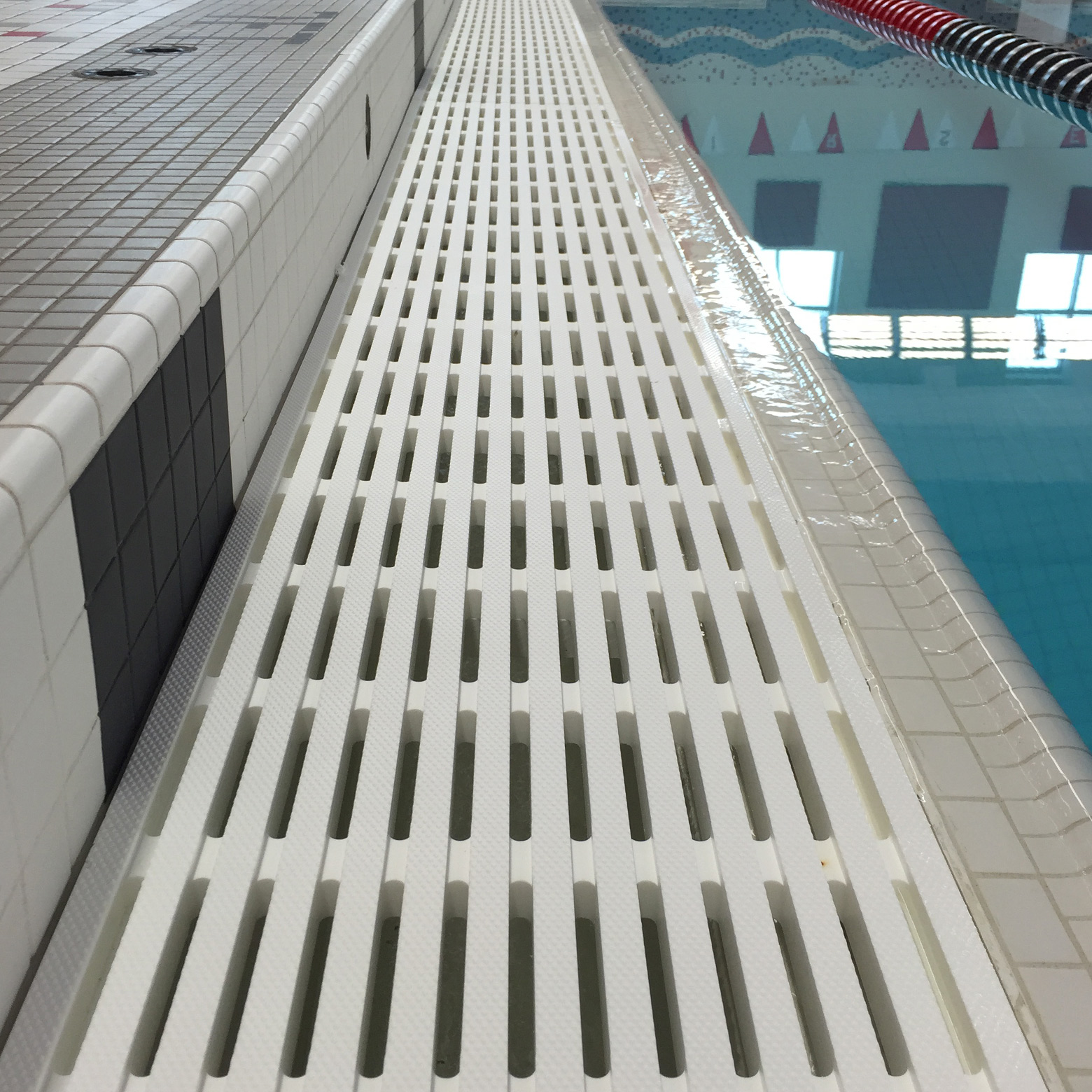 Strong swimming pool gutter grate.